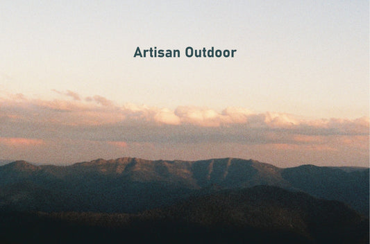 a mountain landscape at sunset with the words "artisan outdoor" placed in the sky